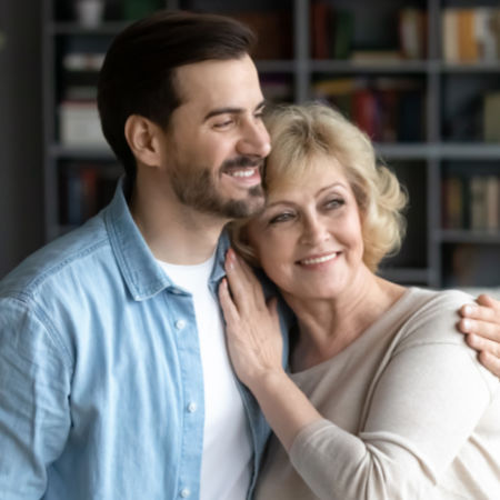 Younger man with older woman embracing