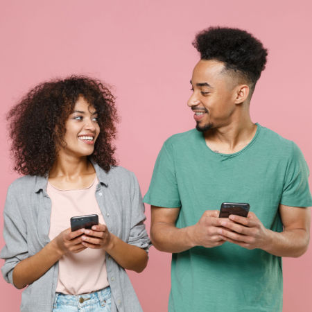 Woman and man texting and smiling