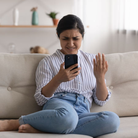 Woman looking at cell phone incredulously