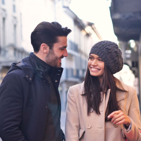 Man and woman meeting on city street