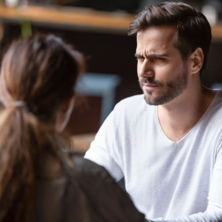 Man looking at his date with judgmental expression