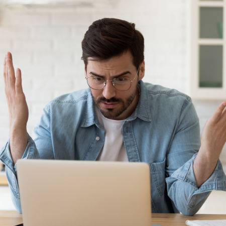 Frustrated man on online speed date looking at his computer