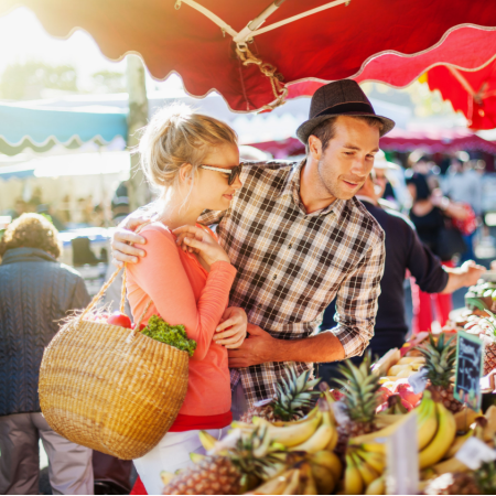 Couple on an outdoor date at a farmers' market