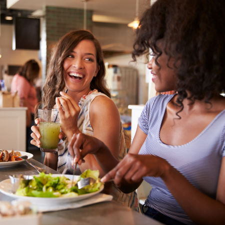 Two confident women on a date looking into each other's eyes