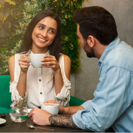 Ex-partners (woman and man) having coffee together and discussing whether to get back together