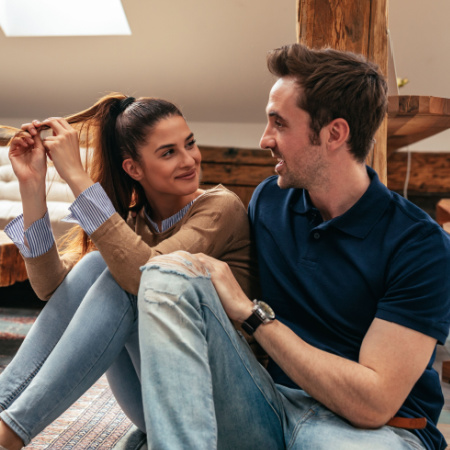 Woman and man sitting on the floor and discussing their future